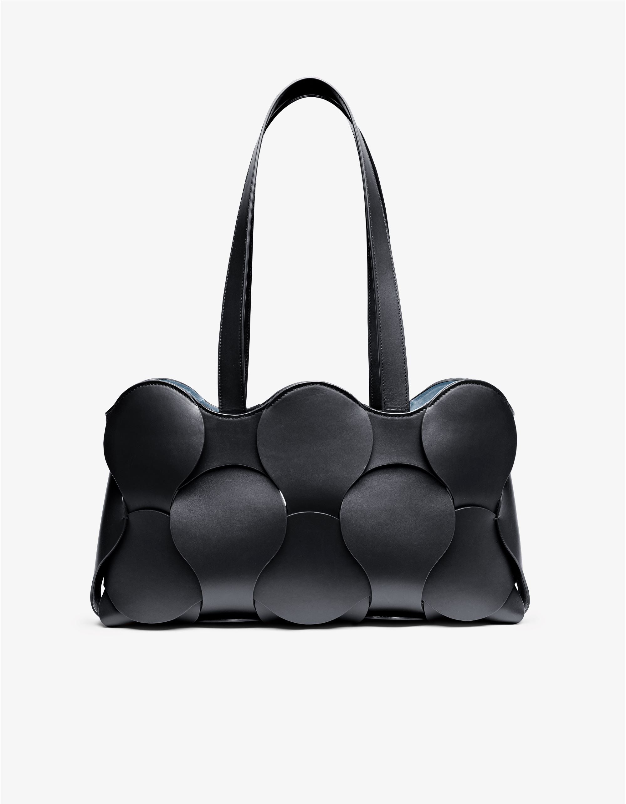 Gigi tote in Black/Sky Italian calfskin leather, handmade in NYC, with woven circular leather motif, removable suede drawstring pouch, and suede-backed interior