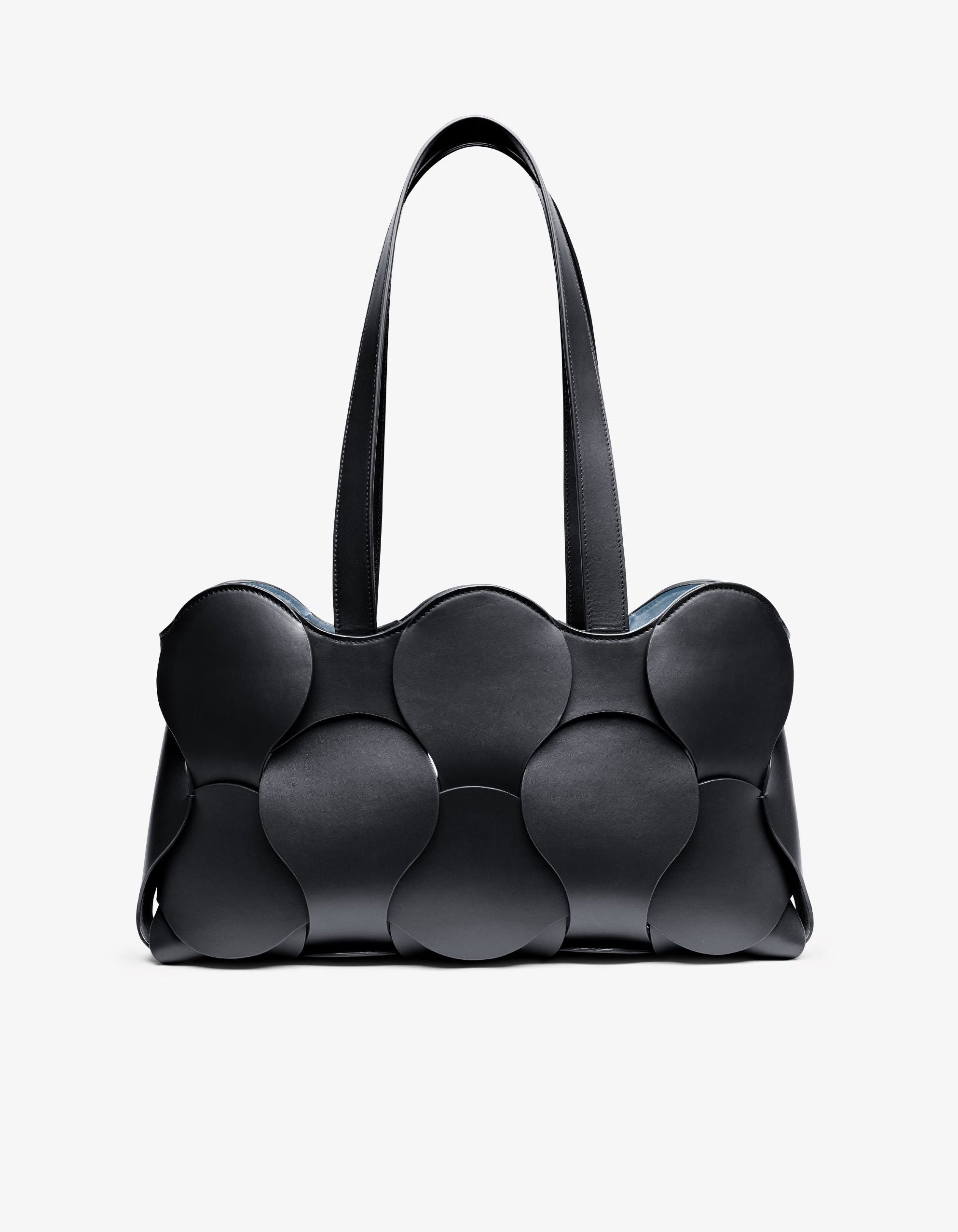 Gigi tote in Black/Sky Italian calfskin leather, handmade in NYC, with woven circular leather motif, removable suede drawstring pouch, and suede-backed interior