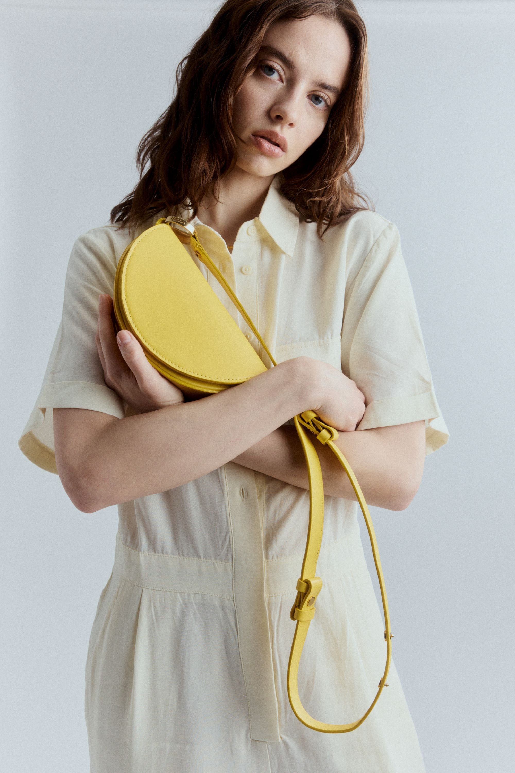 Mini Celeste bag in bright canary Italian leather with clean lines, structured silhouette, and adjustable shoulder or crossbody strap