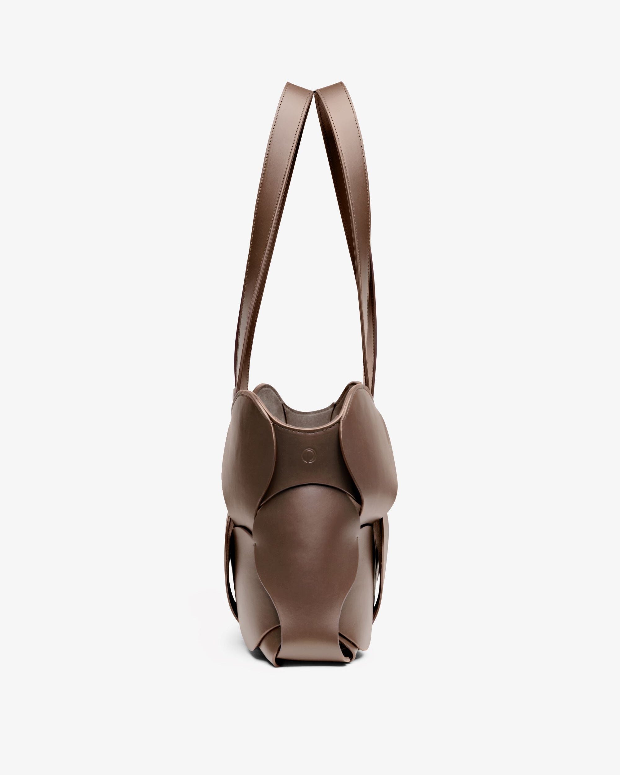 Fawn Gigi tote featuring NYC craftsmanship, sculptural Italian leather, woven circular detail, and removable suede liner.