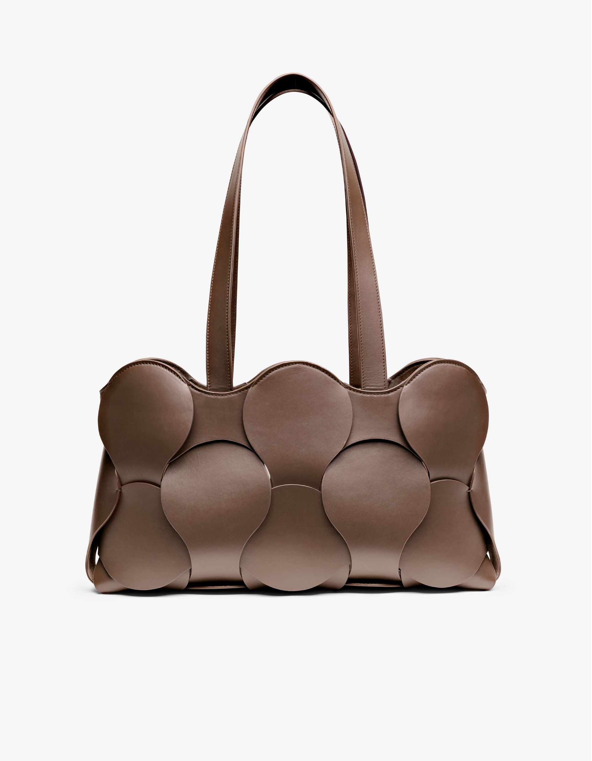 Gigi tote in Fawn Italian calfskin leather, handmade in NYC, with circular woven motif, removable suede drawstring pouch, and suede-backed interior