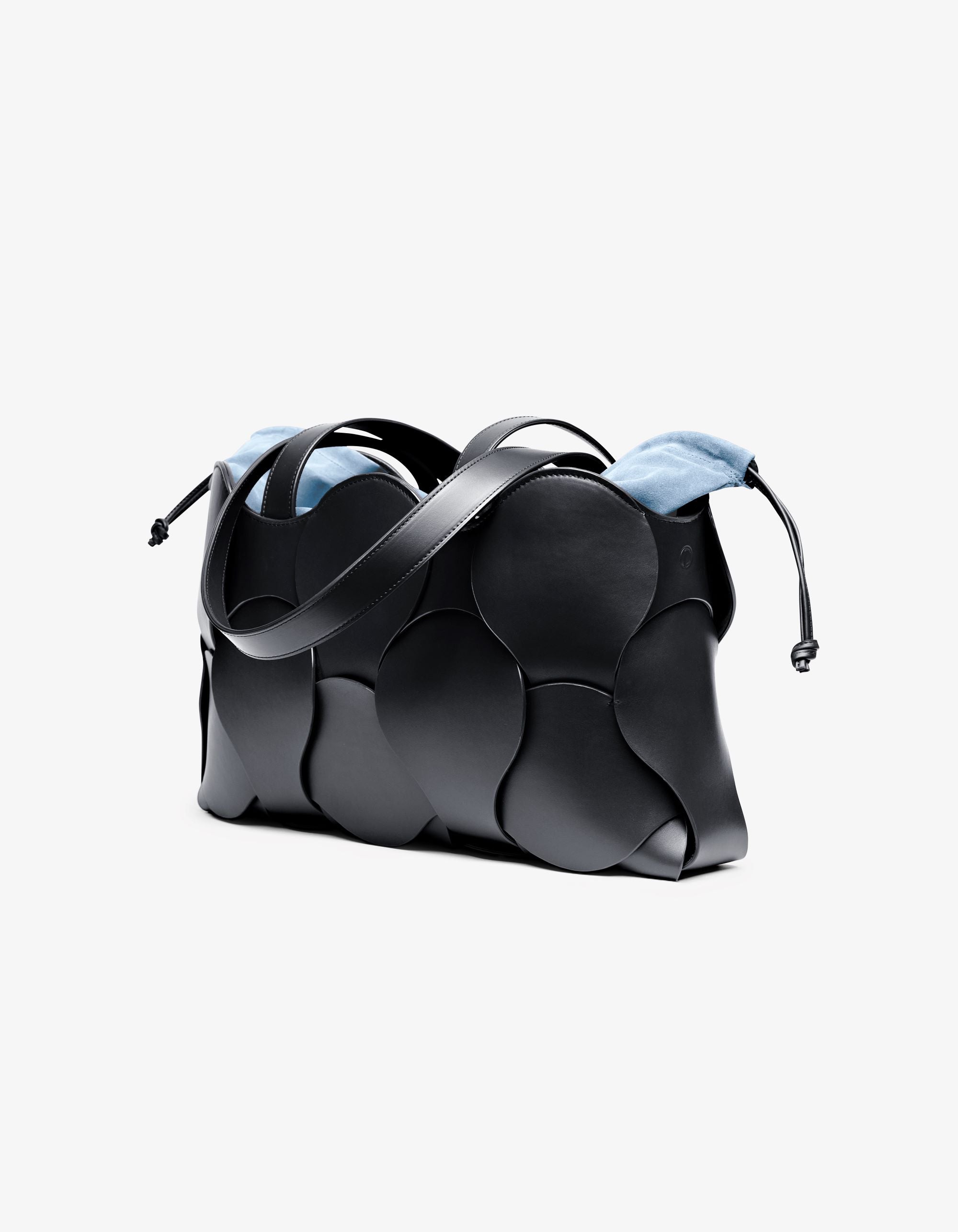 Elegant Gigi tote in Black/Sky leather with woven circular motif, suede-backed interior, and removable drawstring pouch, handcrafted in NYC