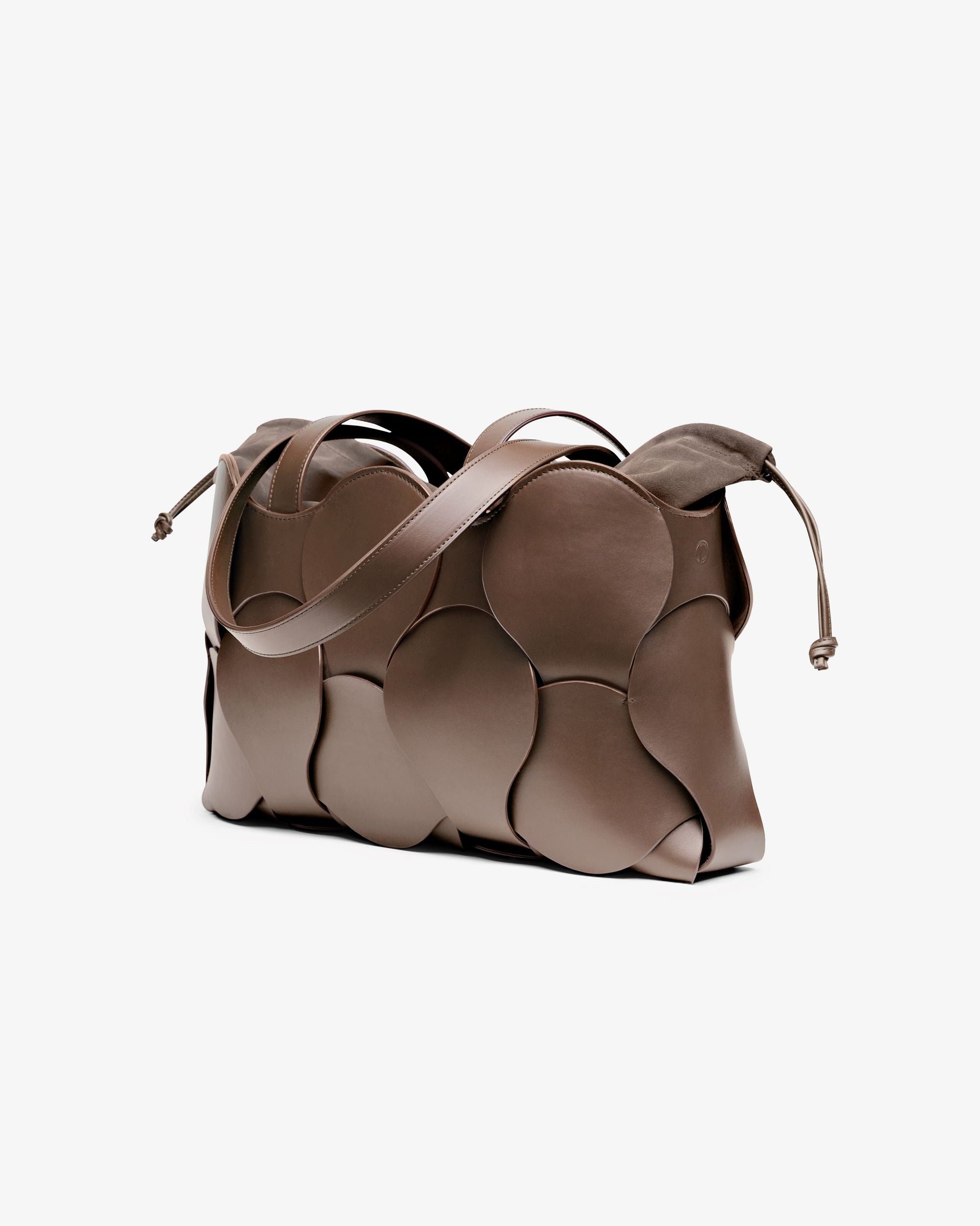 Elegant taupe Gigi tote with woven circular motif, removable suede drawstring pouch, suede-lined interior, and NYC-made quality