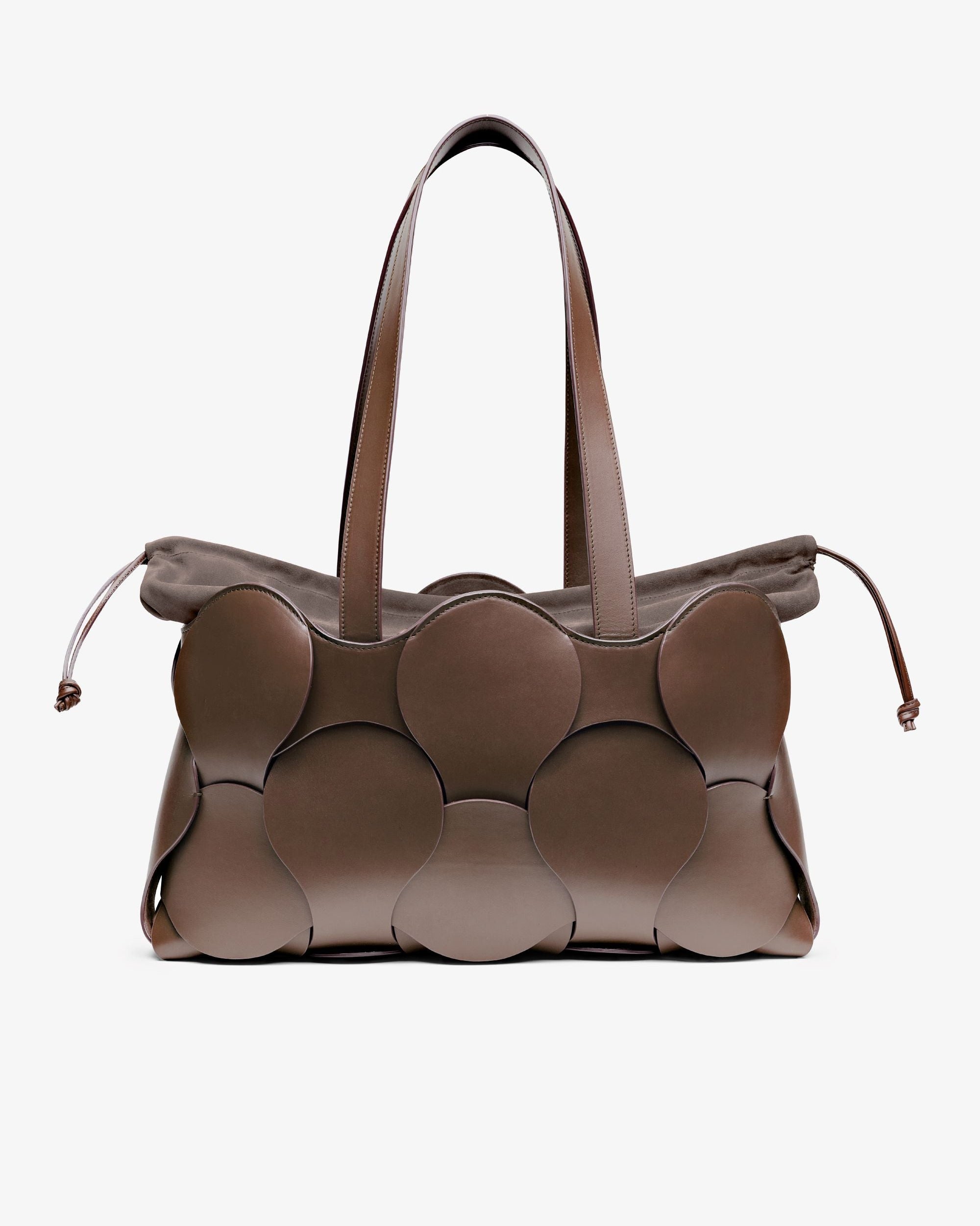A brown Gigi Tote handbag made from Italian calfskin leather with a sculptural form and a removable suede drawstring liner.