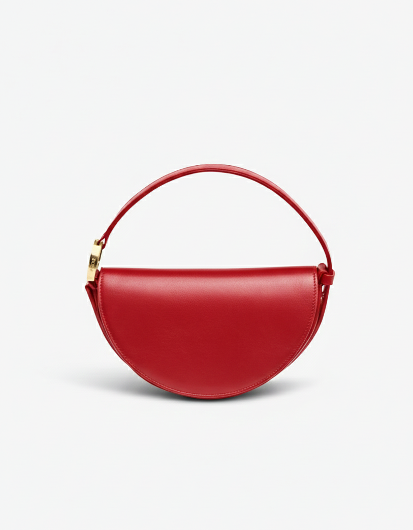 Red handbag with a gold handle on a light gray background