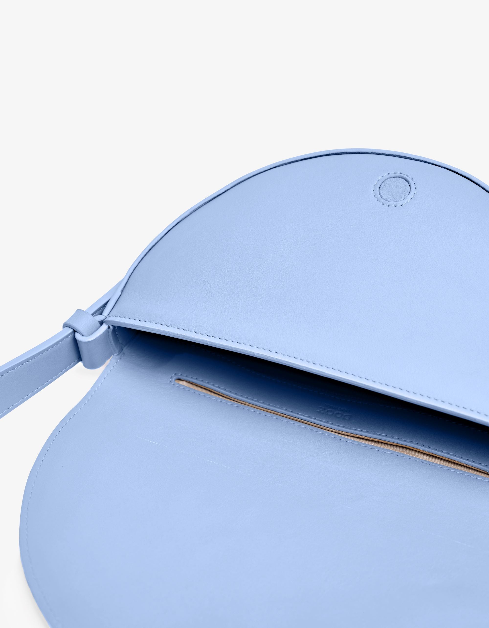 Light blue handbag with a strap on a plain background