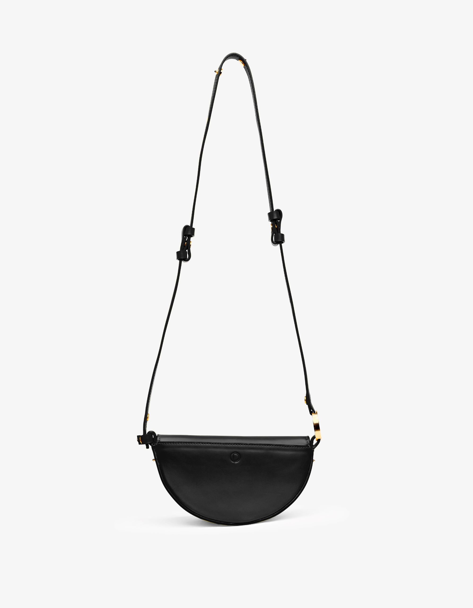 Elegant black Mini Celeste leather handbag with minimalist architectural design and versatile carrying options