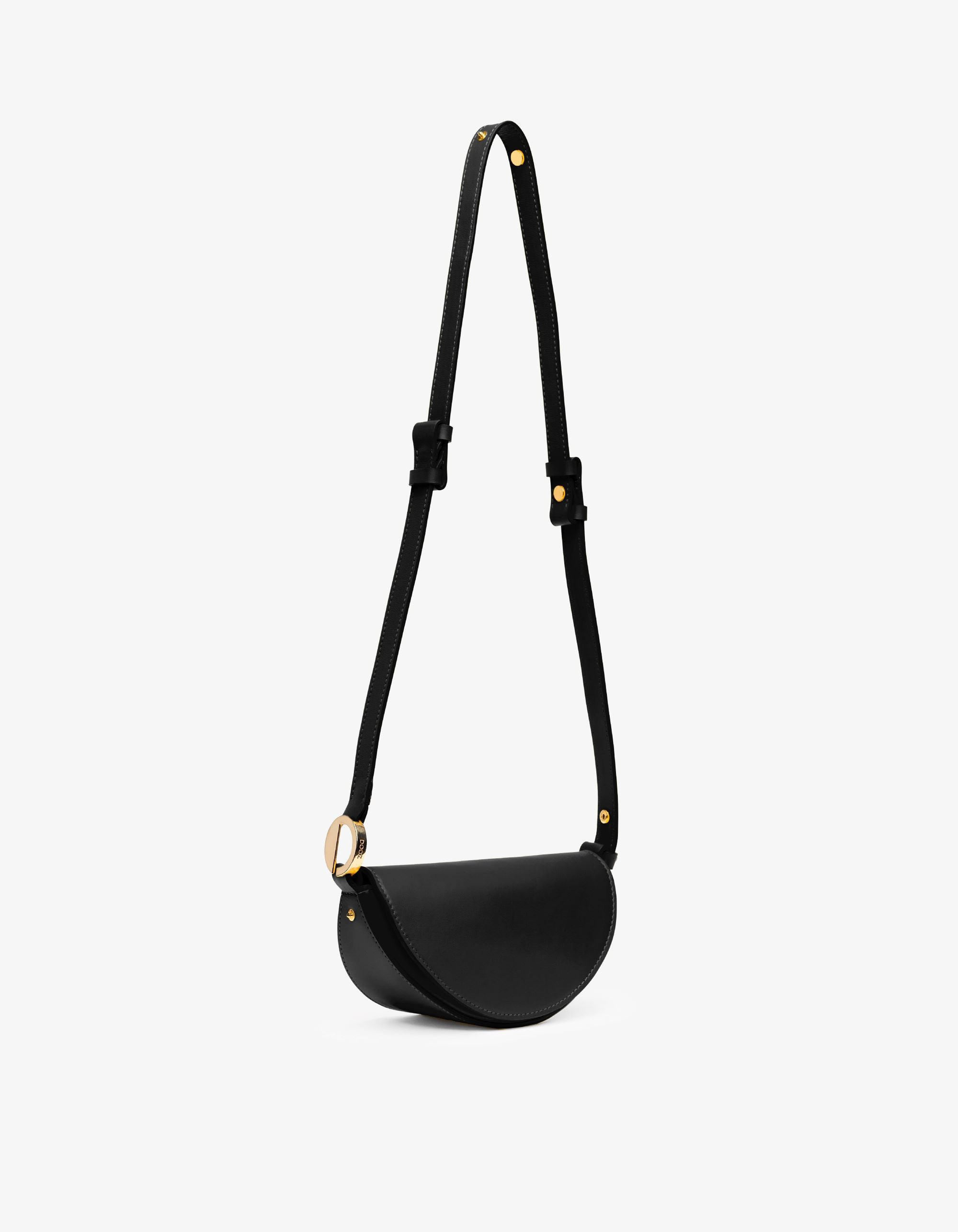 Black Mini Celeste bag with sleek sculptural silhouette, hand-stitched Italian leather, and adjustable strap