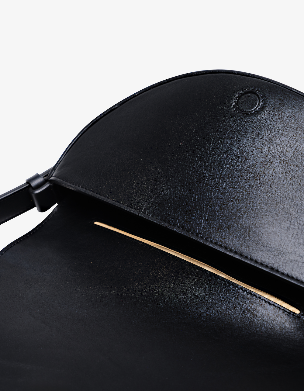 Black Celeste leather handbag with minimalist architectural design, polished hardware, and convertible carrying options