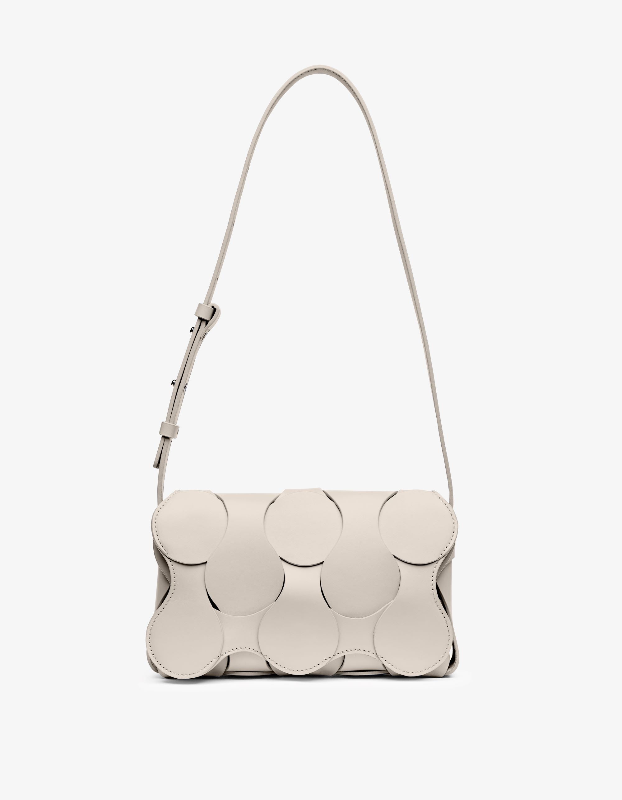 Parchment Gigi bag with NYC craftsmanship, sculptural Italian leather design, magnetic flap closure, and circular woven detail