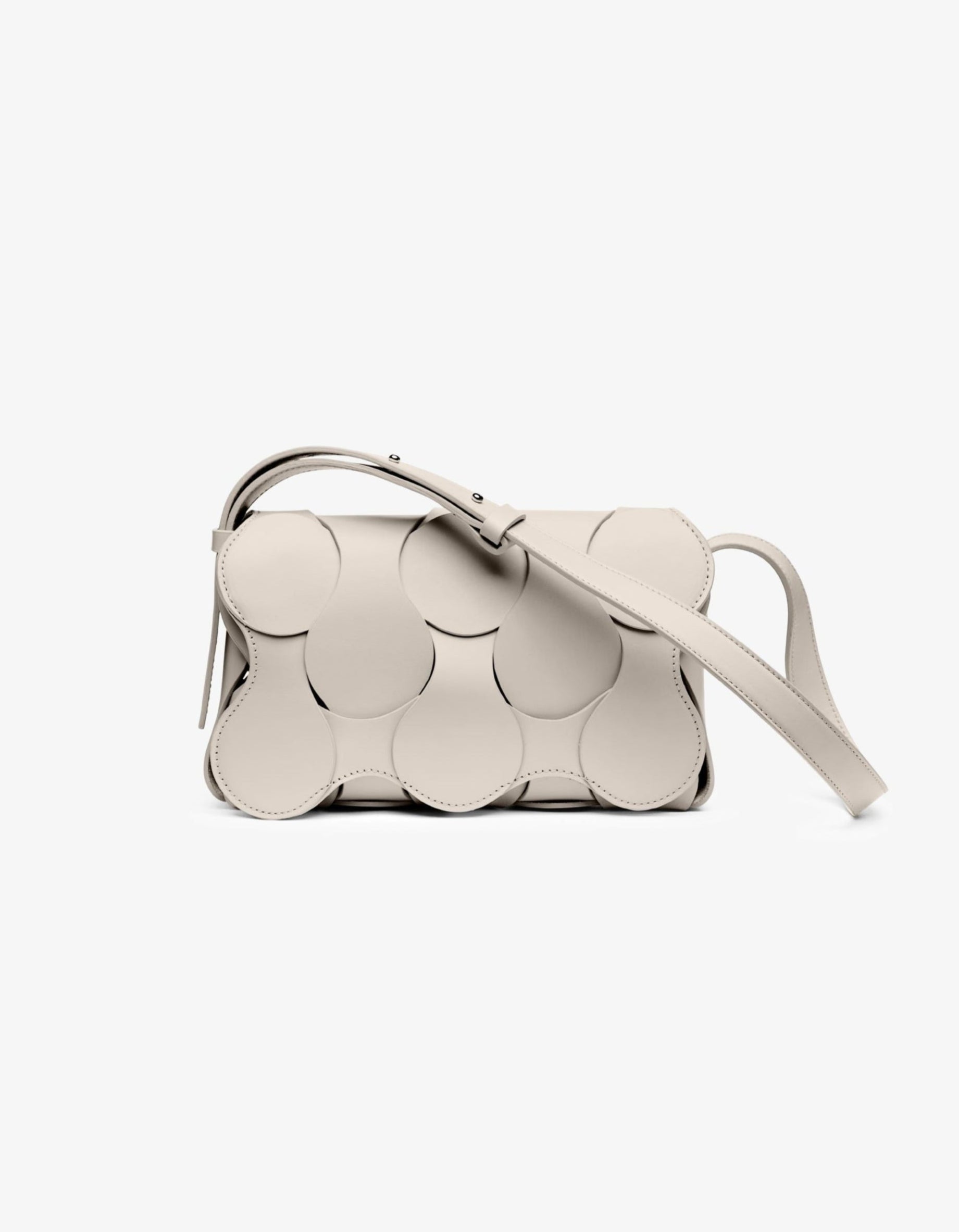 A white leather handbag with a unique sculptural design, featuring a smooth surface and a shoulder strap.