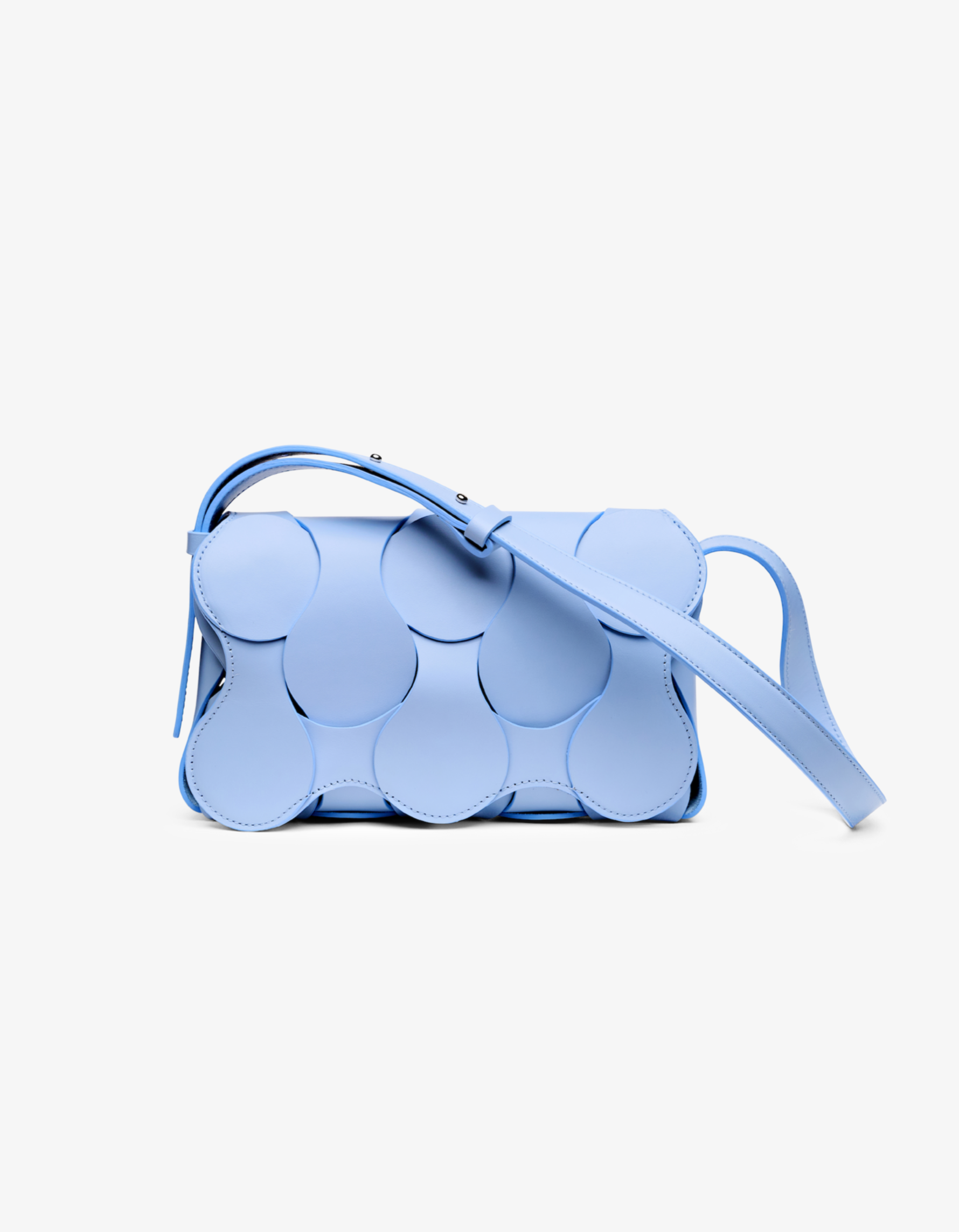 A light blue handbag with a unique sculptural design, made from smooth leather, with a shoulder strap.