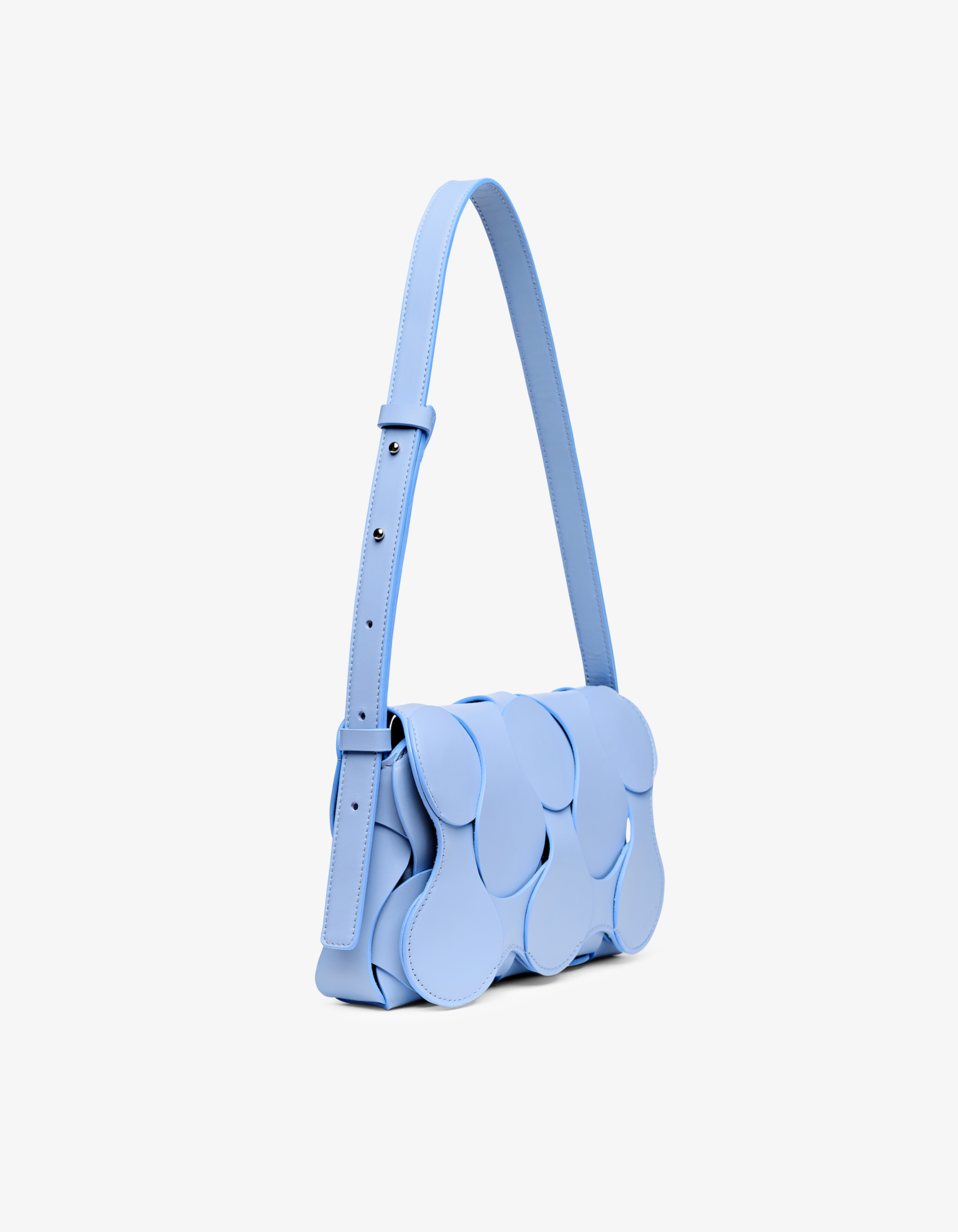 Gigi bag in sky blue Italian calfskin leather, handmade in NYC, with woven circular leather motif, magnetic flap, and shoulder or crossbody strap