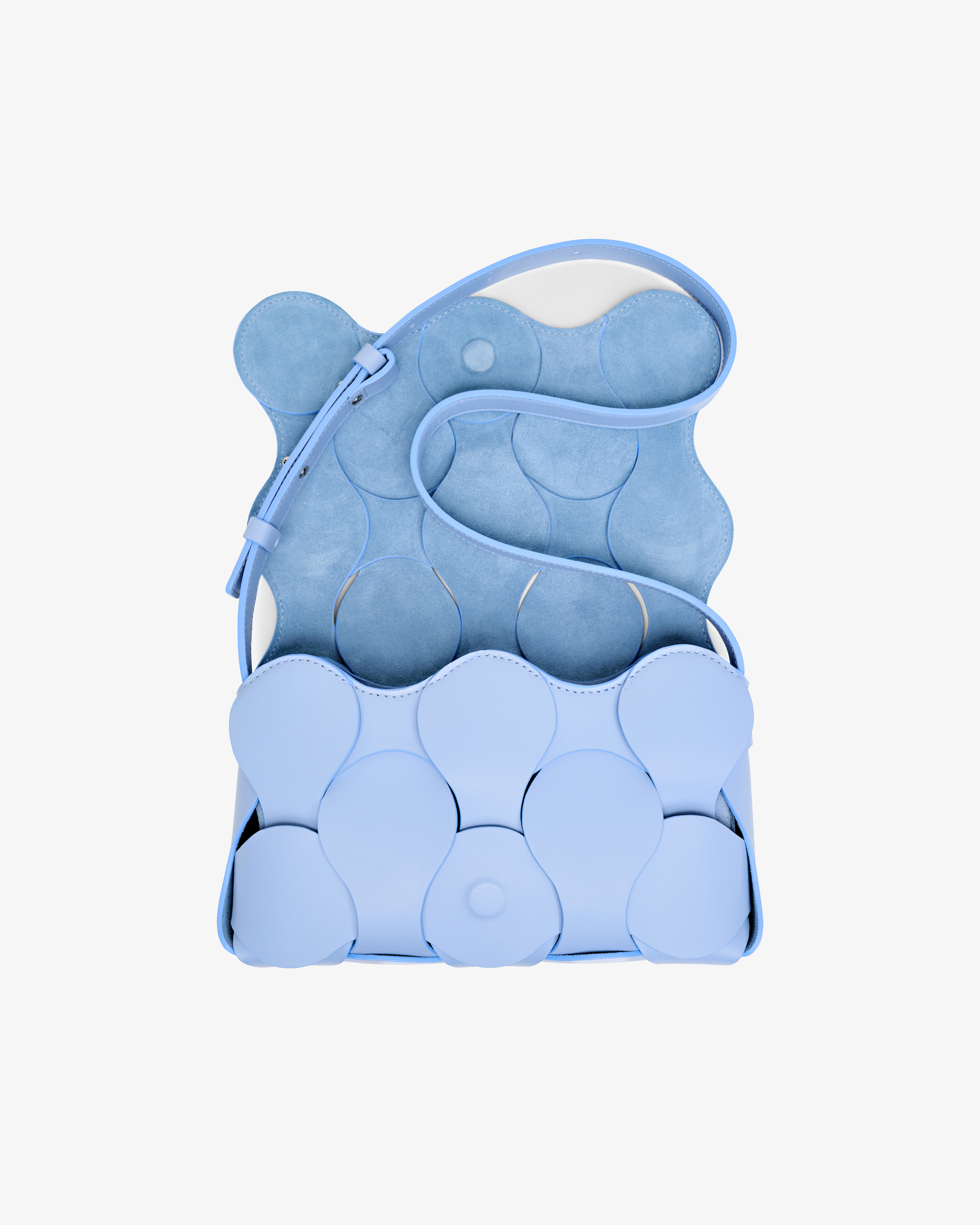 Sky blue Gigi bag with NYC artisan craftsmanship, sculptural form, woven circular motif, and versatile magnetic flap closure