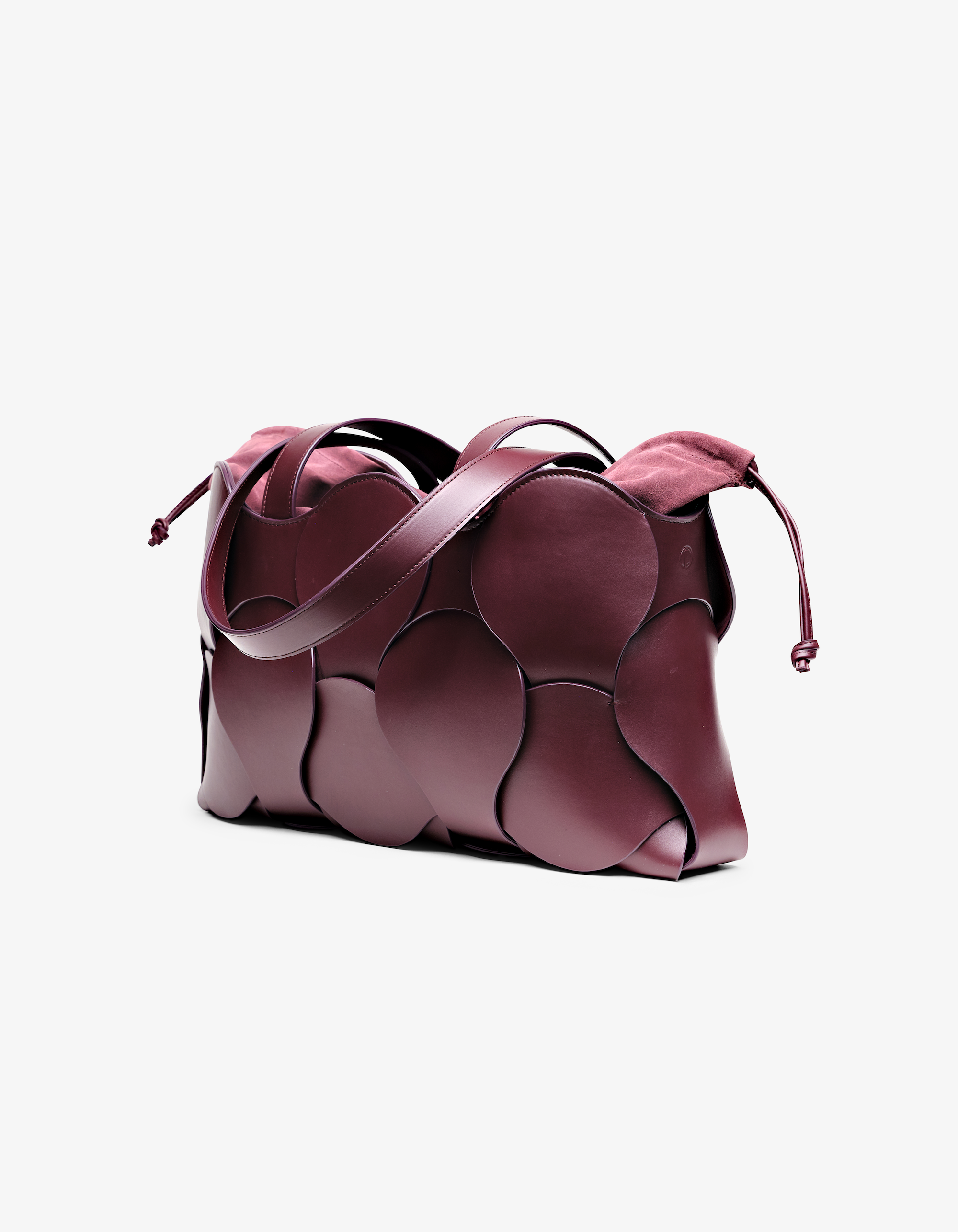 Elegant bordeaux Gigi tote with woven circular motif, removable suede pouch, suede-lined interior, and NYC-made quality