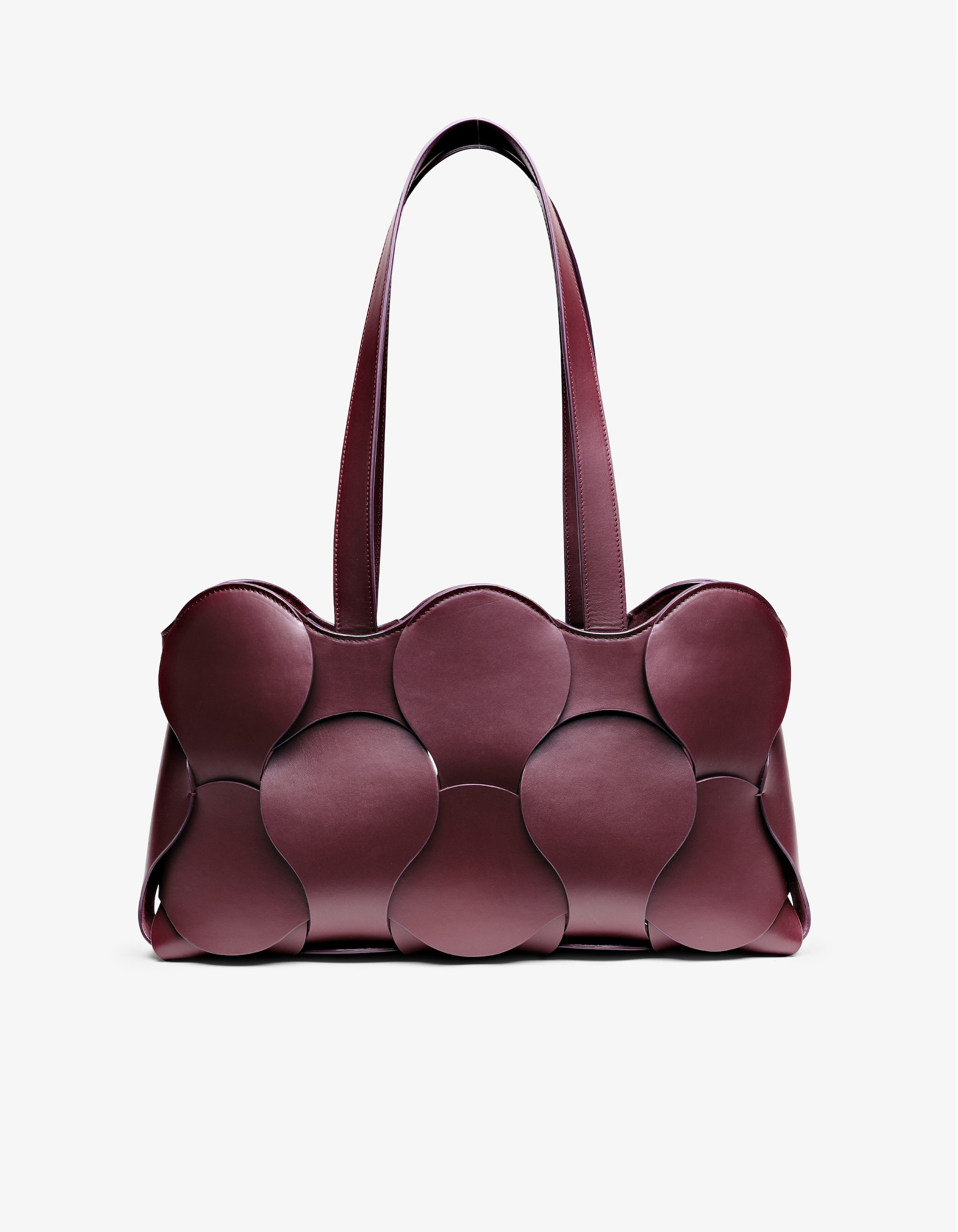 Gigi tote in Oxblood Italian calfskin leather, handmade in NYC, with circular woven motif, removable suede drawstring pouch, and suede-backed interior