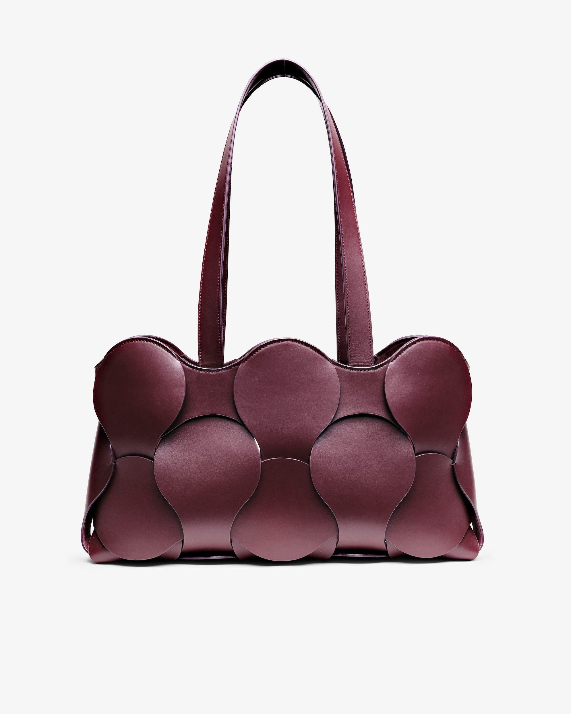 Gigi tote in Oxblood Italian calfskin leather, handmade in NYC, with circular woven motif, removable suede drawstring pouch, and suede-backed interior