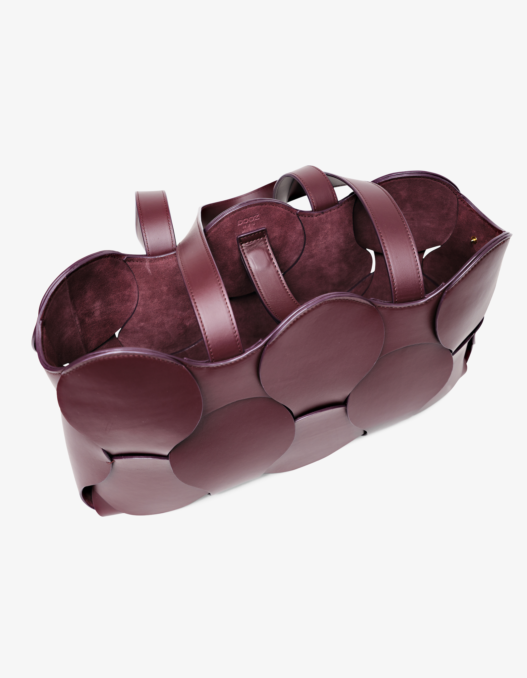 Dooz Gigi tote in Oxblood Italian leather, sculptural design, circular woven detail, suede-backed interior, and removable drawstring pouch