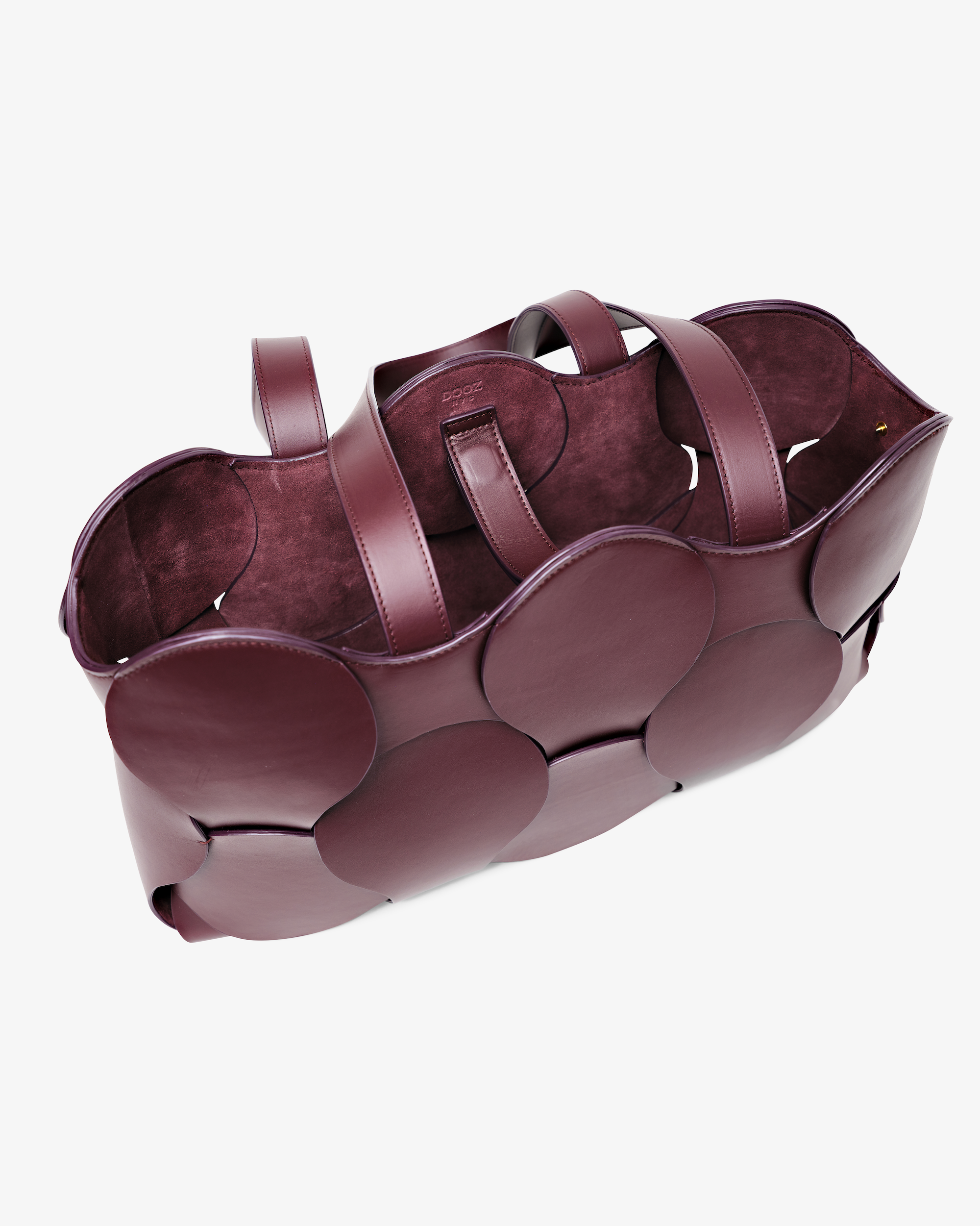 Dooz Gigi tote in Oxblood Italian leather, sculptural design, circular woven detail, suede-backed interior, and removable drawstring pouch