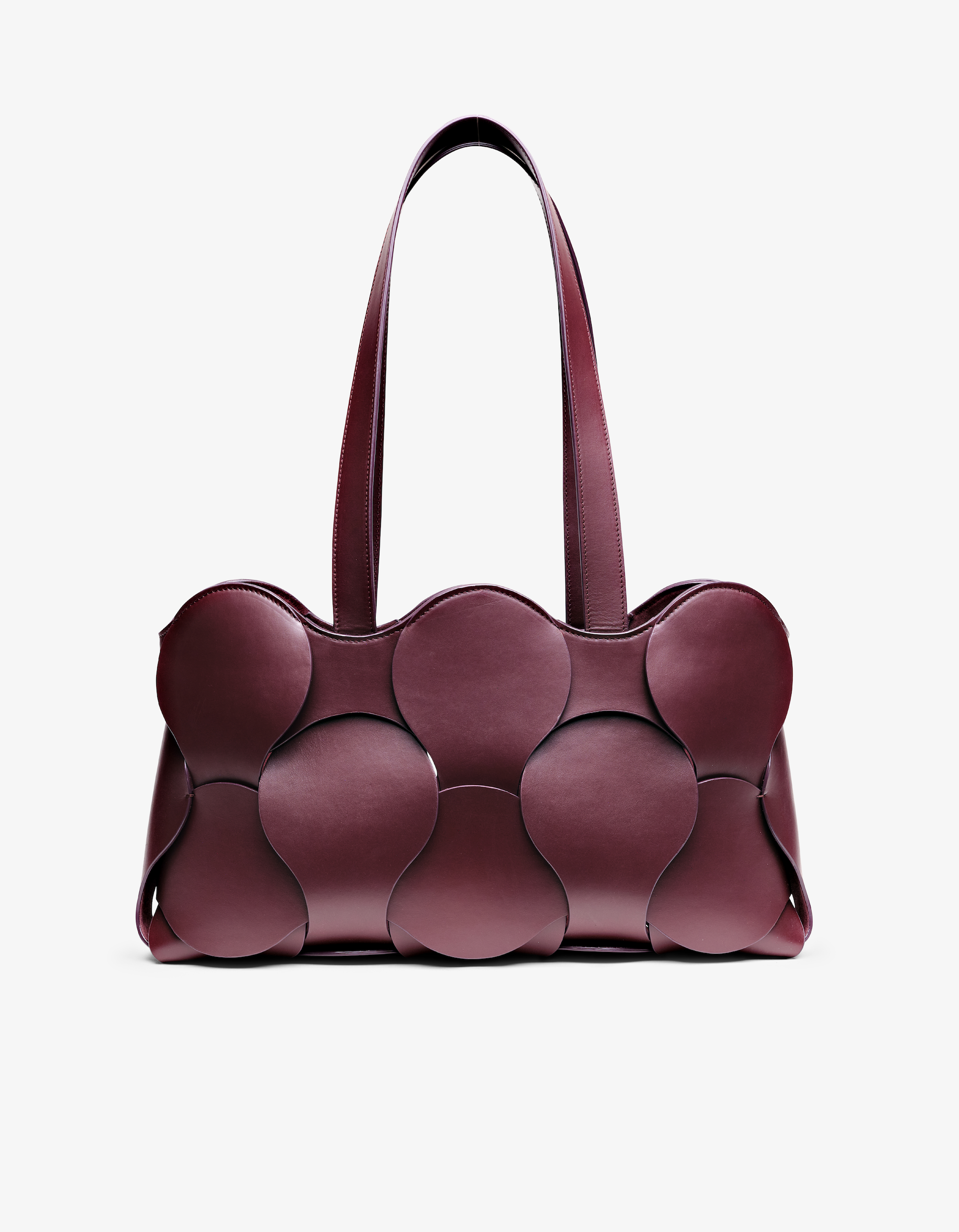Gigi tote in Oxblood Italian calfskin leather, handmade in NYC, with circular woven motif, removable suede drawstring pouch, and suede-backed interior