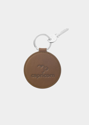 Dooz Capricorn olive green leather keychain with embossed zodiac glyph and silver keyring
