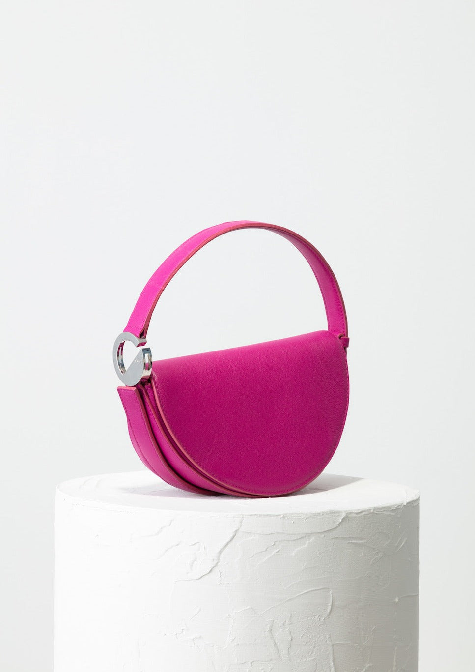 Dooz Sagittarius fuchsia pink leather half moon handbag with front magnetic flap and short strap
