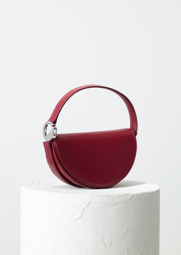 Dooz Virgo burgundy leather half moon handbag with short strap and magnetic front flap modern design