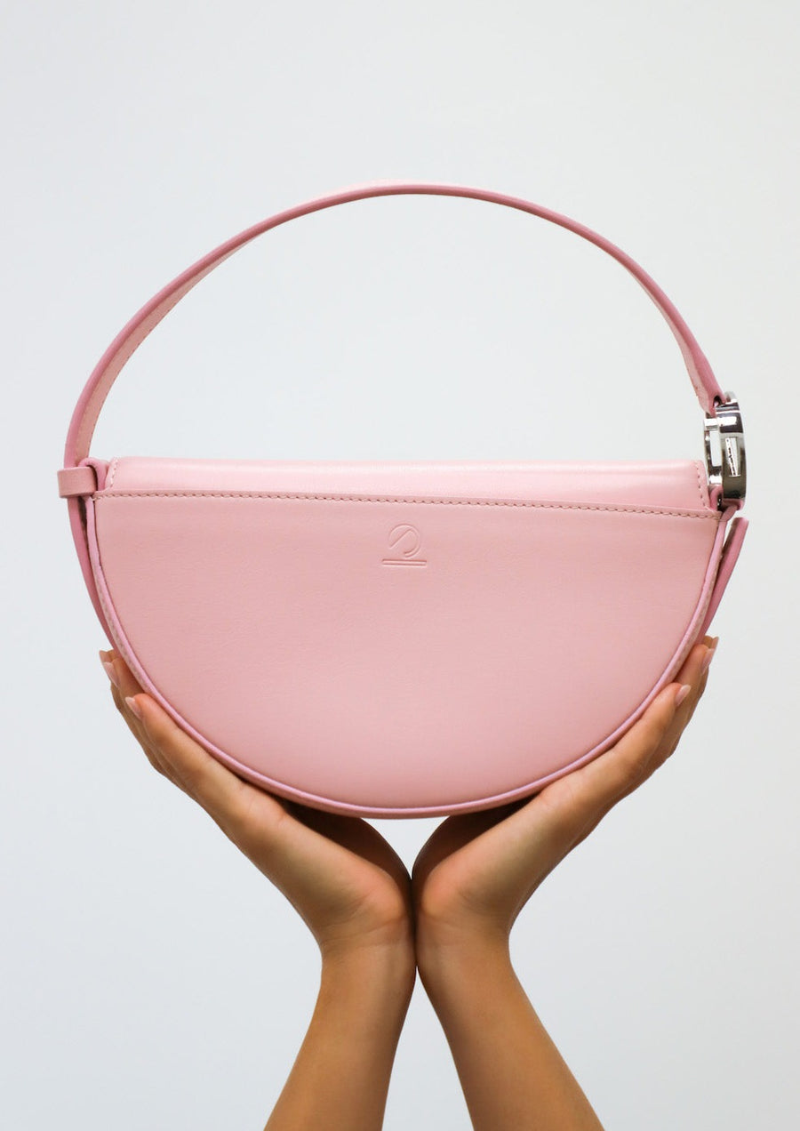 Dooz libra zodiac sign embossed on back pocket of circular handbag minimal design pale pink leather