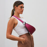 Dooz sagittarius hot pink leather handbag crossbody purse with silver logo hardware half moon shape