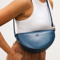 Dooz cancer dark teal blue leather crossbody strap handbag with embossed logo zodiac sign